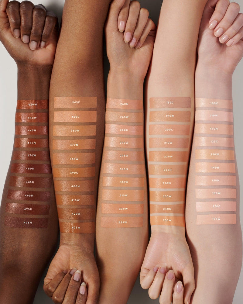 Fenty Beauty's collection of We're Even Hydrating Longwear Concealer shades for light, light-medium, medium, medium-deep or tan, and deep skin tones shown as arm swatches on models of various skin tones