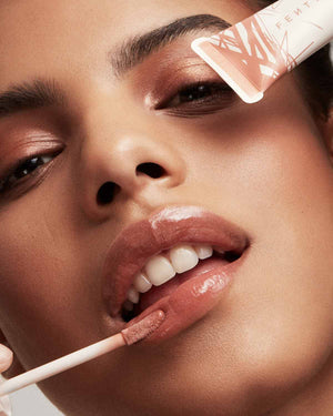 Close up of medium deep skin-toned model wearing Pro Kiss'r Luscious Lip Balm in shade Latte Lips.